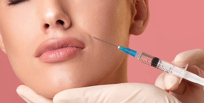 Provider injecting Belotero Balance filler into a patient's lips