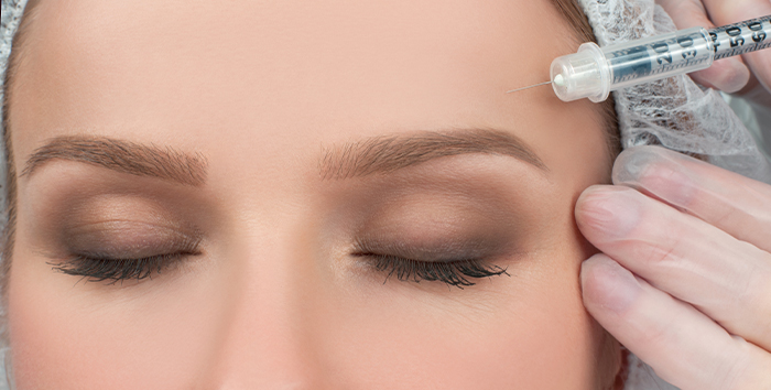 Provider injecting Dysport near a patient's brow area