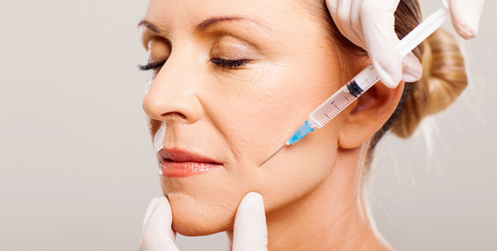 Provider injecting Juvéderm filler into a patient's cheek
