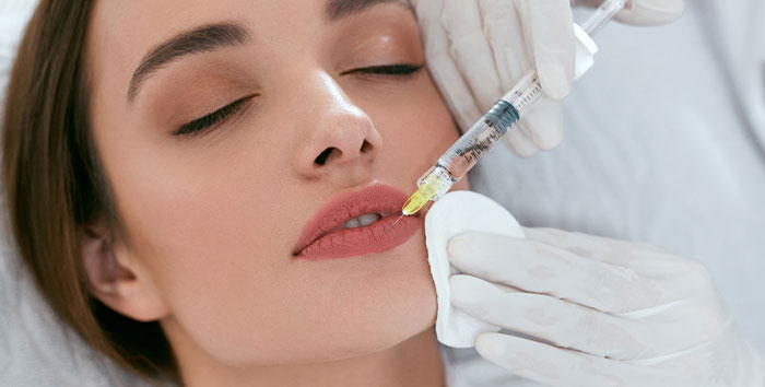 Provider injecting RHA Collection filler into a patient's lips